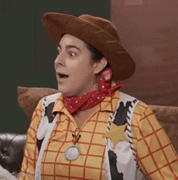 a woman is dressed as woody from toy story .