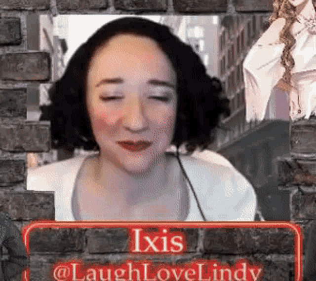 a woman is sitting in front of a brick wall with her eyes closed