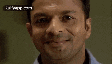 a close up of a man 's face with a smile on it .