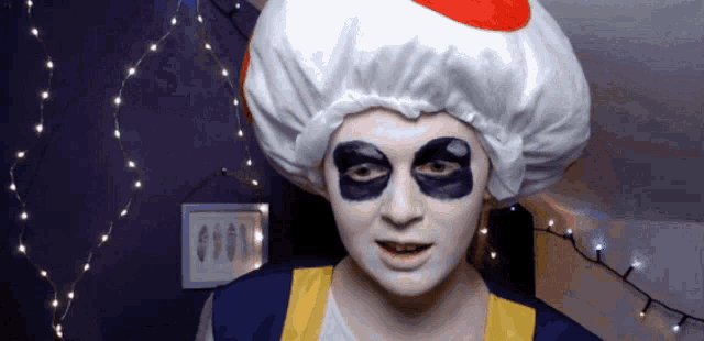 a person in a toad costume with black eye patches