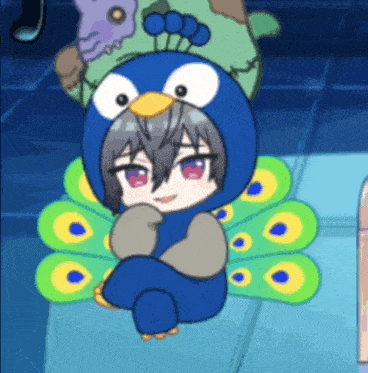 a person in a peacock costume is sitting on the floor