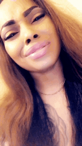 a close up of a woman 's face with a smile on her face