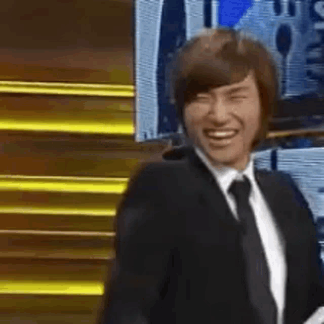 a man in a suit and tie is smiling
