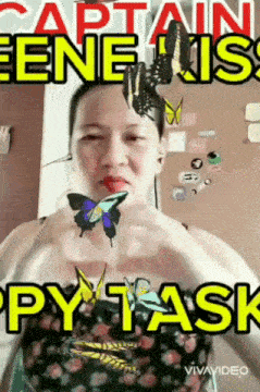 a woman is holding two butterflies in her hands and says captain gene