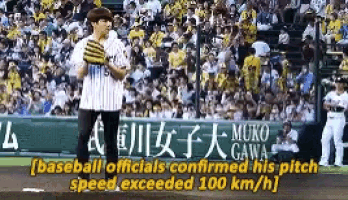 a baseball player is throwing a pitch in front of a crowd of people