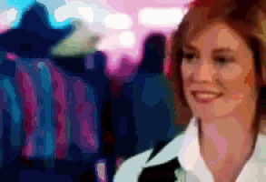 a pixelated image of a woman smiling in front of a blurry background
