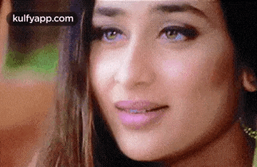 a close up of a woman 's face with a slight smile on her face .