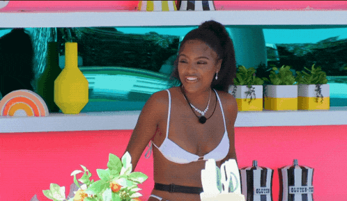 a woman in a bikini stands in front of a cake that says 10