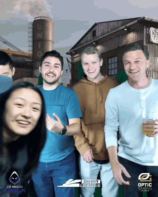 a group of people are posing for a photo with a call of duty league logo in the background