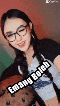 a girl wearing glasses and a shirt that says " emang bolch "