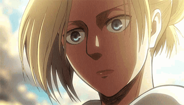 a close up of a woman 's face with a blue sky in the background