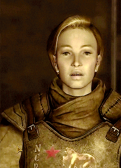 a woman wearing a brown vest with a red star on the back