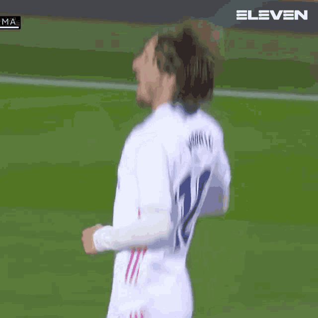 a soccer player wearing a white shirt with emirates on the front