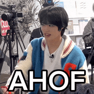 a man wearing a blue and white sweater with the word ahof written on it
