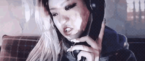 a woman is wearing headphones and talking on a phone .