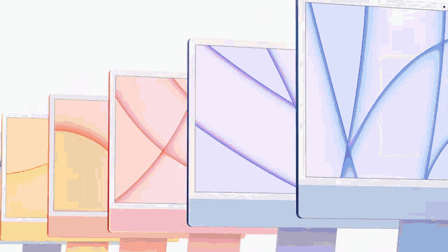 three different colored computer monitors are lined up on a white surface