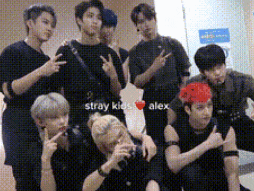 a group of young men are posing for a picture and one of them has a red headband on .