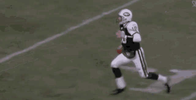 two football players are playing a game of football on a field . one of the players is wearing a number 9 jersey .