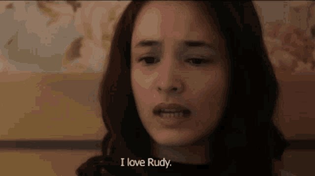 a woman is saying i love rudy in a close up of her face