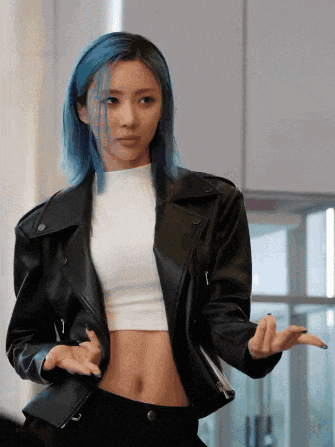 a woman with blue hair is wearing a black leather jacket and a white top