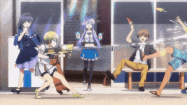 a group of people are playing with water guns
