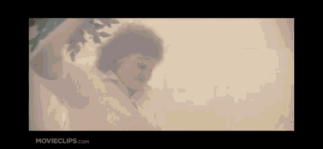a woman in a white shirt is standing in a foggy room holding a tree branch .
