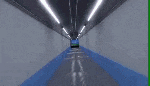 a tunnel with a view of a soccer field in the distance .
