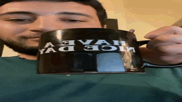 a man is holding a mug that says " nice day "