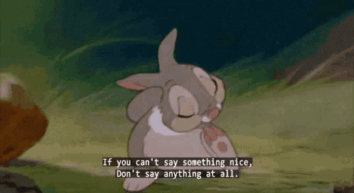 a cartoon rabbit is sitting in the grass with a quote .