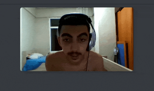 a man without a shirt is wearing headphones