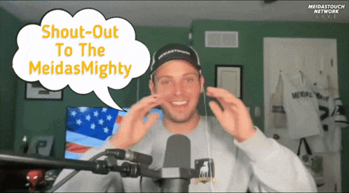 a man in front of a microphone with a speech bubble that says " shout-out to the meidas mighty "