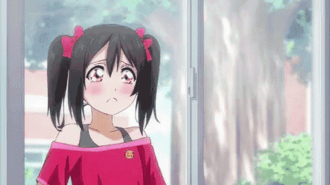 a girl with pigtails is standing in front of a window looking out .