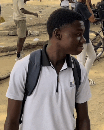 a young man wearing a white shirt with a letter h on it