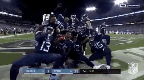 a football game is being played between the jaguars and the titans .
