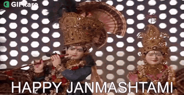 two statues of krishna and radha are playing a flute in front of a wall with polka dots .