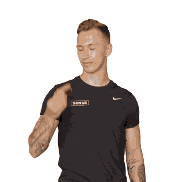 a man wearing a black shirt that says sense