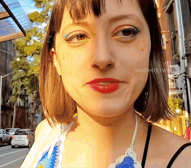 a close up of a woman 's face with the word dino written on it