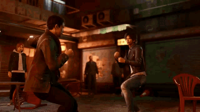 a man in a leather jacket is fighting another man