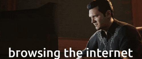 a man is sitting in front of a computer screen with the words browsing the internet above him