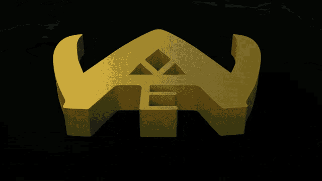 a gold triangle with a diamond in the middle is on a black background