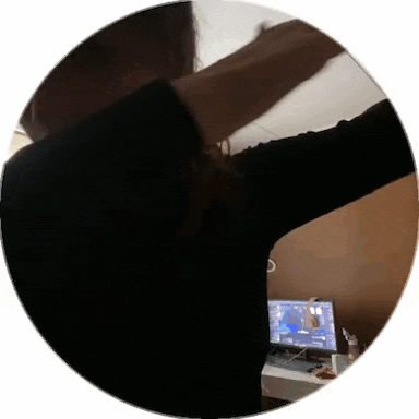 a woman is standing in front of a computer with her arms outstretched