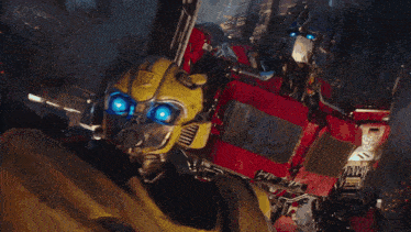 bumblebee and optimus prime from the movie transformers are standing next to each other