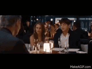 a group of people sitting at a table with makeagif.com written on the bottom of the screen