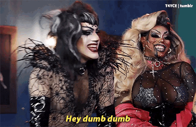 two drag queens are posing for a picture and one of them says hey dumb dumb
