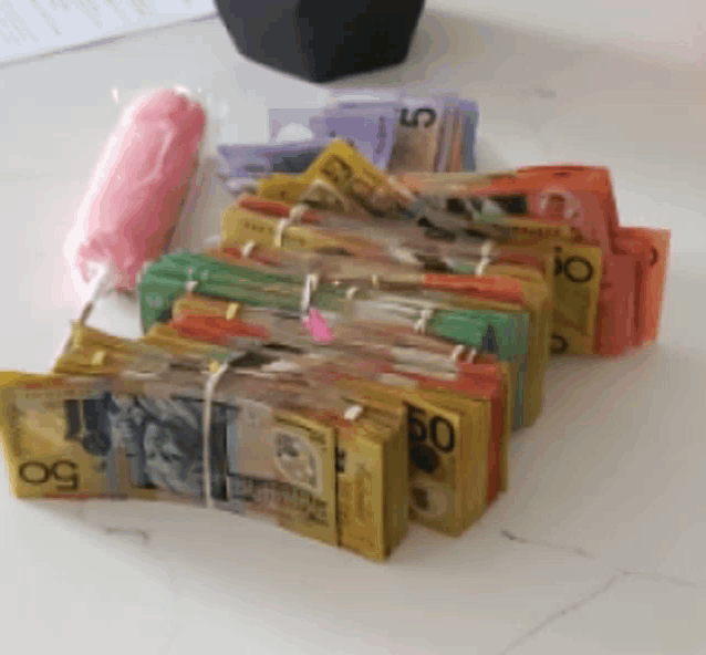 a stack of 50 dollar bills are tied together on a table