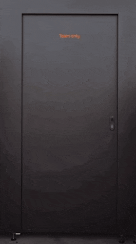 a young man is standing in a doorway with his arms crossed .