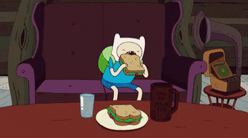 a cartoon character sitting on a couch eating a sandwich next to a mug that says i love you mom