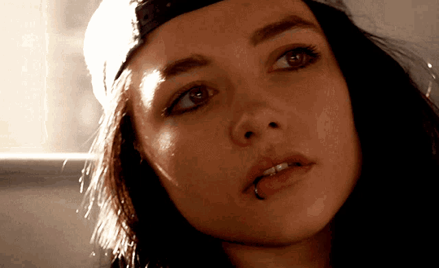 a close up of a woman 's face with a piercing in her tongue