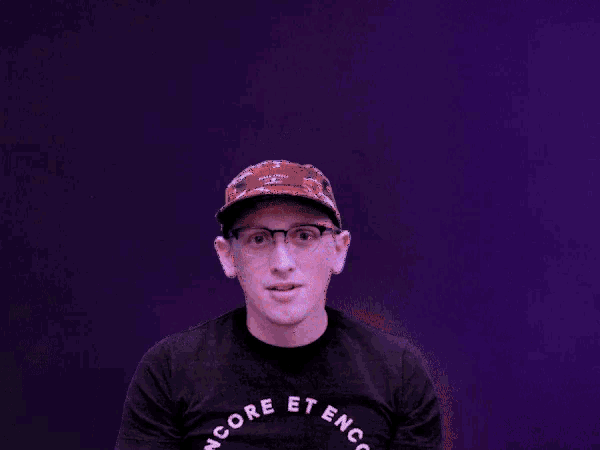 a man wearing glasses and a hat with the words truly don 't care above his head