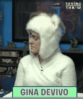 gina devivo is wearing a white furry hat and sweater
